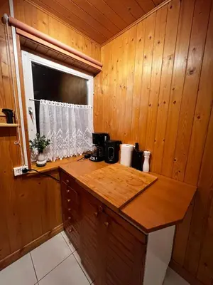 a kitchen with wooden walls and a wooden counter top at Świerkowa Chata in Targanice