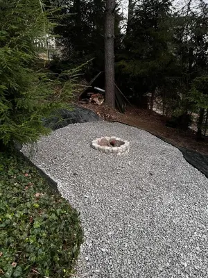 a cat laying on top of a pile of gravel at Świerkowa Chata in Targanice