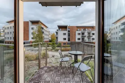 a balcony with two chairs and a table with a view at Dębniki Comfort Studio by BookingHost in Kraków