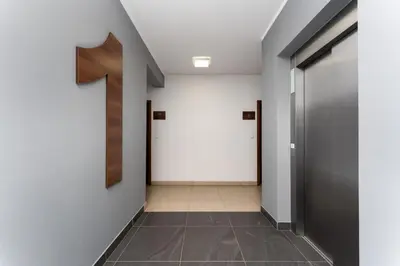 a hallway with a number one on the wall at Dębniki Comfort Studio by BookingHost in Kraków