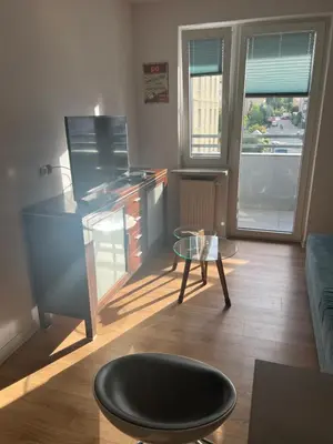a living room with a desk and a table at Ruczaj Cozy Room in Kraków