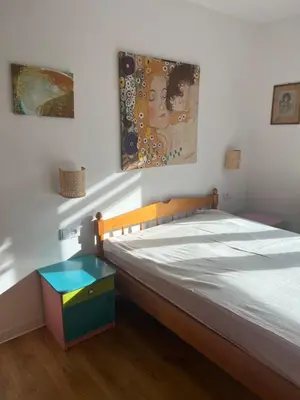a bedroom with a bed with a wooden frame at Ruczaj Cozy Room in Kraków