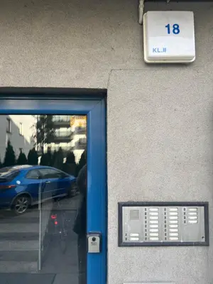 a door to a building with a sign on it at Ruczaj Cozy Room in Kraków