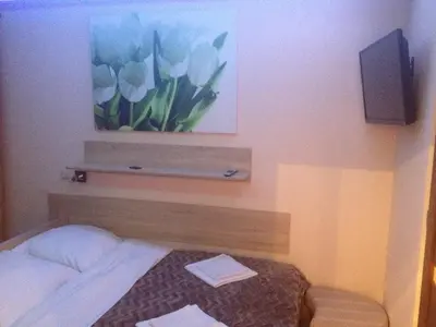 a hotel room with a bed and a picture of flowers at Hotel Mis in Bochnia