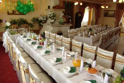 a long table with white tables and chairs in a room at Hotel Mis in Bochnia