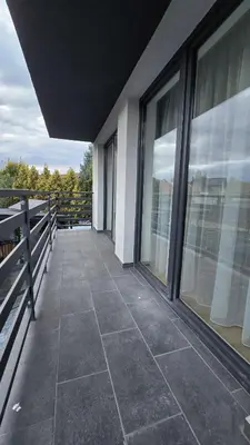 a balcony of a building with large windows at Apartamenty Żurawia 1- Piętro 2 in Kraków