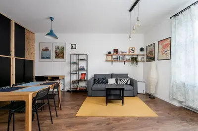 a living room with a couch and a table at Bocheńska Modern Apartment by BookingHost in Kraków
