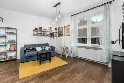 a living room with a couch and a table at Bocheńska Modern Apartment by BookingHost in Kraków
