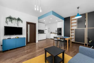 a living room with a couch and a table at Bocheńska Modern Apartment by BookingHost in Kraków