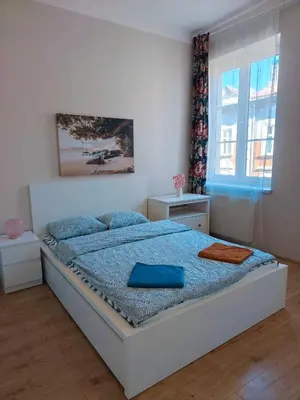a bedroom with a bed with blue pillows on it at Krakow City Stay - City Vibes, Historic Charm in Kraków