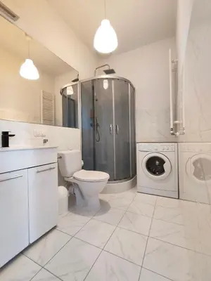 a bathroom with a toilet and a washing machine at Krakow City Stay - City Vibes, Historic Charm in Kraków