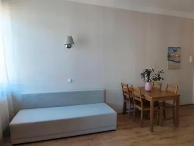 a room with a table and a bed and a table and chairs at Krakow City Stay - City Vibes, Historic Charm in Kraków