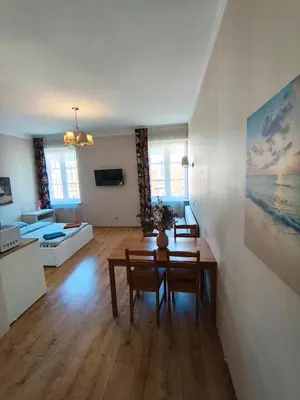 a living room with a table and a couch at Krakow City Stay - City Vibes, Historic Charm in Kraków