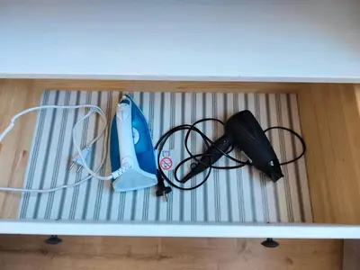 a shelf with a wii controller and other cords at Krakow City Stay - City Vibes, Historic Charm in Kraków