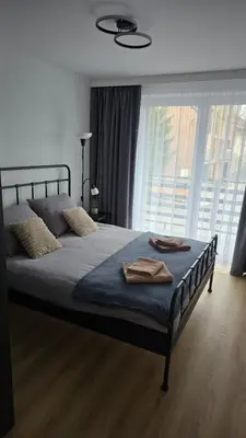 a bedroom with a bed with two towels on it at Apartamenty Żurawia 1 - Piętro 1 in Kraków