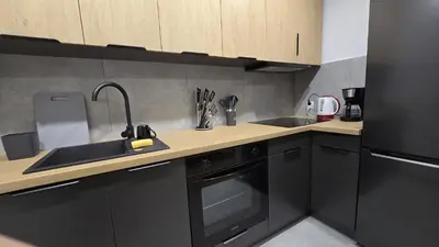 a kitchen with a sink and a stove at Apartamenty Żurawia 1 - Piętro 1 in Kraków