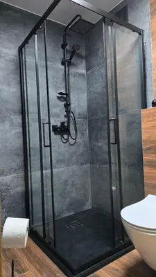 a shower with a glass door in a bathroom at Apartamenty Żurawia 1 - Piętro 1 in Kraków