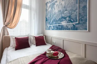 a bedroom with a bed with a tray on it at Colora Apartments by MB Apartments in Kraków