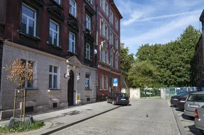 a car parked on a street next to a building at Apartament Tenczyńska in Kraków