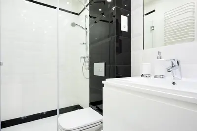 a bathroom with a sink and a shower at Apartament Tenczyńska in Kraków