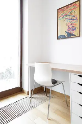 a white desk with a chair in a room at Househost Apartment Plac Na Groblach 5 in Kraków