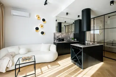 a living room with a white couch and a table at Fancy 2bdr Golden Dots apartment in city centre in Kraków