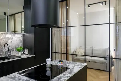 a kitchen with a sink and a living room at Fancy 2bdr Golden Dots apartment in city centre in Kraków