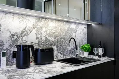 a kitchen with a counter top with a sink at Fancy 2bdr Golden Dots apartment in city centre in Kraków