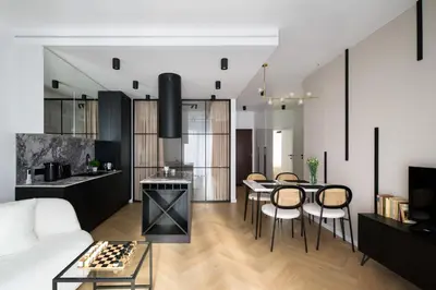 a living room with a white couch and a table and chairs at Fancy 2bdr Golden Dots apartment in city centre in Kraków