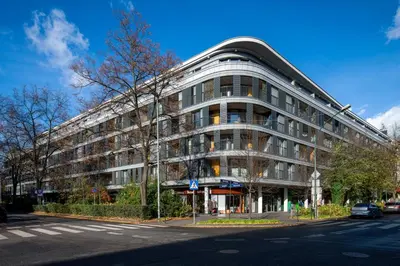 a large building on the corner of a street at Fancy 2bdr Golden Dots apartment in city centre in Kraków
