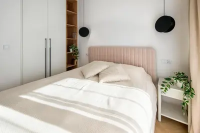 a bedroom with a white bed with two pillows at Fancy 2bdr Golden Dots apartment in city centre in Kraków