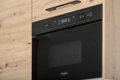 a black microwave oven sitting on top of a counter at Aleja Kijowska Kraków Modern Apartment with Balcony and Parking by Noclegi Renters in Kraków