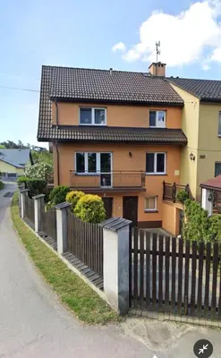 a house with a fence in front of it at Dom w Kryspinowie in Kryspinów