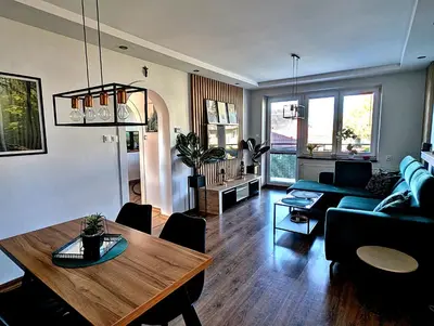 a living room with a table and a couch at Dom w Kryspinowie in Kryspinów