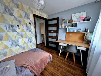 a bedroom with a desk and a bed and a table at Dom w Kryspinowie in Kryspinów
