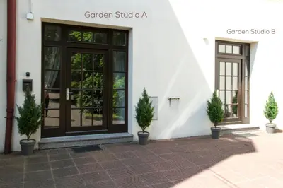a door of a building with potted plants in front at Garden Studio in Kraków