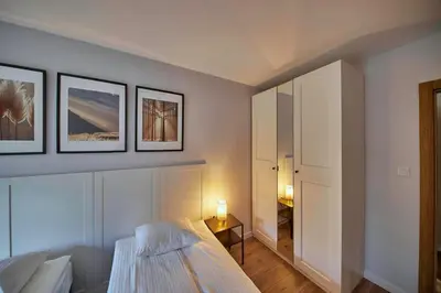 a bedroom with a bed and three pictures on the wall at Przytulne M w Pcimiu in Pcim