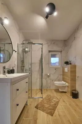 a bathroom with a shower and a sink and a toilet at Przytulne M w Pcimiu in Pcim