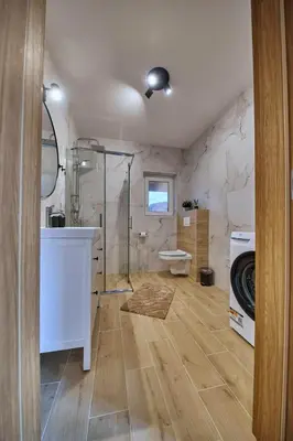 a bathroom with a shower and a sink and a toilet at Przytulne M w Pcimiu in Pcim