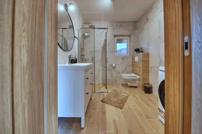a bathroom with a shower and a sink and a toilet at Przytulne M w Pcimiu in Pcim