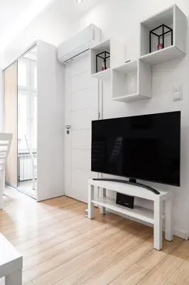 a living room with a large flat screen tv at Househost Apartment Paulinska 20 in Kraków