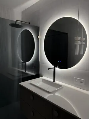 a bathroom with a sink and two mirrors at O2 Premium Residence in Kraków