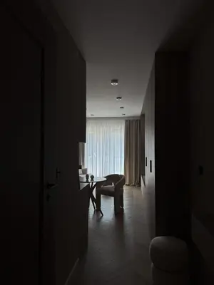 a dark room with a table and a chair and a desk at O2 Premium Residence in Kraków