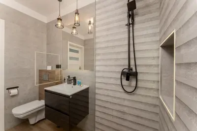 a hallway with a white door and a staircase at Kraków Grzegórzki Deluxe Studio by BookingHost in Kraków