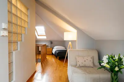 a living room with a couch and a bed at Native Apartments Warszauera 3 in Kraków