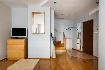 a living room with a tv and a couch at Native Apartments Warszauera 3 in Kraków