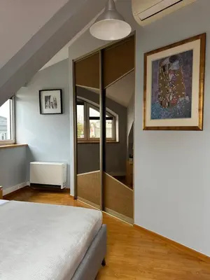 a bedroom with a bed and a sliding glass door at Native Apartments Warszauera 3 in Kraków