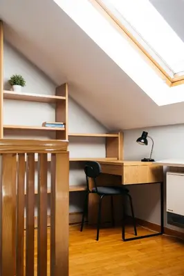 a desk in a attic with a skylight at Native Apartments Warszauera 3 in Kraków