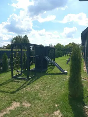 a playground with a slide in the grass at Sister's House Zator in Palczowice