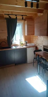 a kitchen with a counter and a table and a window at Sister's House Zator in Palczowice